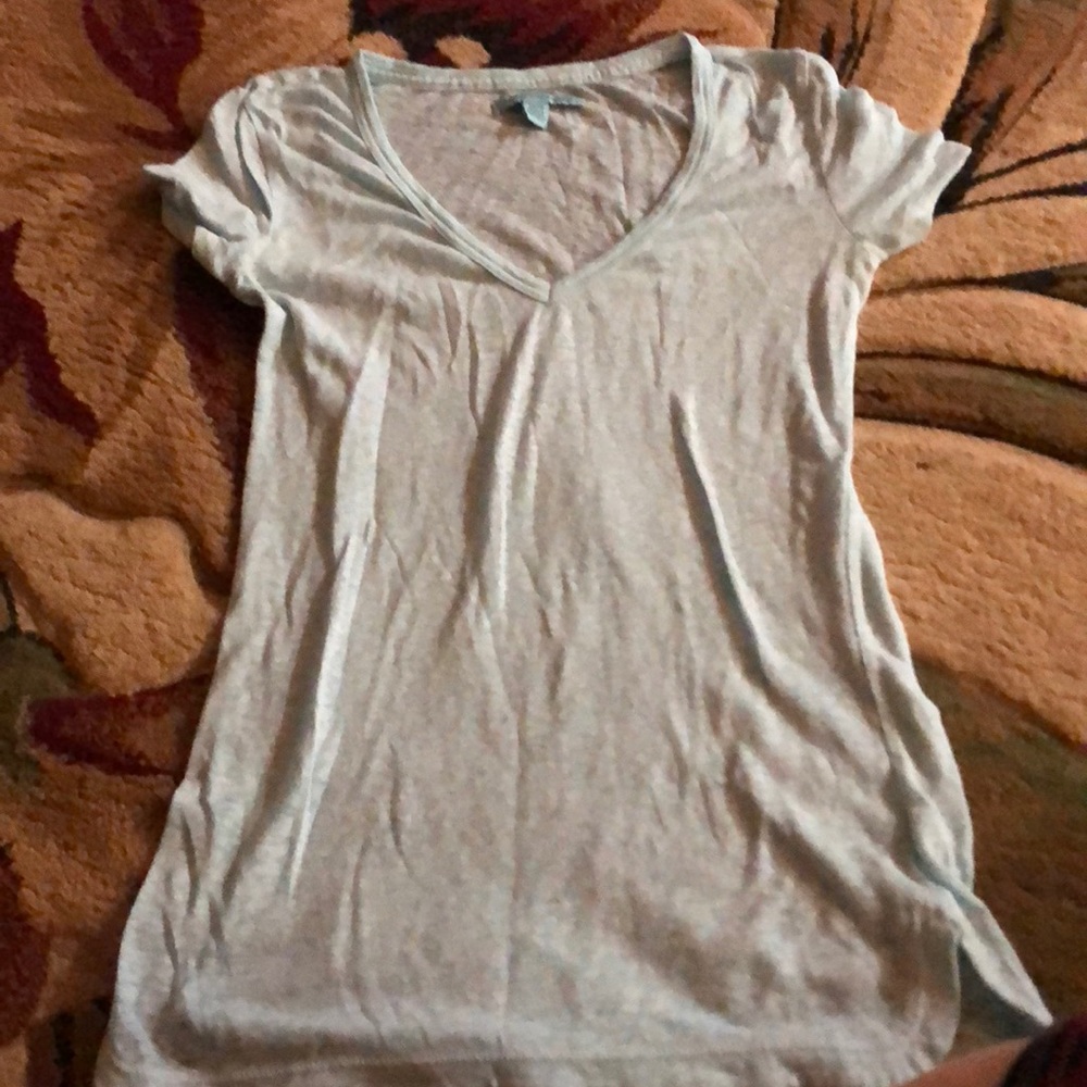 V-neck blue shirt.